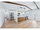 Well-lit kitchen features stainless steel appliances, a center island, and white cabinets and countertops at 1332 Marjohn Ave, Clearwater, FL 33756