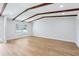 Bright and open living room with wood-look flooring and rustic ceiling beams at 1332 Marjohn Ave, Clearwater, FL 33756