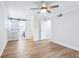 This main bedroom features a barn door and hardwood floors, creating an airy feel and providing privacy at 1332 Marjohn Ave, Clearwater, FL 33756