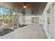 A screened-in patio with ceiling fans, designed for enjoying serene backyard views and outdoor living at 1332 Marjohn Ave, Clearwater, FL 33756