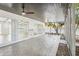 A tiled, screened-in patio with ceiling fans, ideal for outdoor relaxation and entertainment at 1332 Marjohn Ave, Clearwater, FL 33756