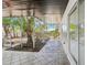 Relaxing sunroom with decorative tile flooring and screened walls overlooking the lush backyard at 1332 Marjohn Ave, Clearwater, FL 33756