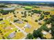 Aerial view of a neighborhood surrounded by open fields and trees at 13338 Jaudon Ranch Rd, Dover, FL 33527