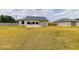 Expansive backyard with a patio, lush greenery, a privacy fence, and a detached garage offering ample space at 13338 Jaudon Ranch Rd, Dover, FL 33527