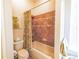Full bathroom features a tub with a shower, tiled walls, and a patterned shower curtain at 13338 Jaudon Ranch Rd, Dover, FL 33527