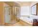 Elegant bathroom with glass-enclosed shower and relaxing soaking tub at 13338 Jaudon Ranch Rd, Dover, FL 33527