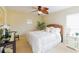 Light-filled bedroom with a bed, white linens, neutral walls, and carpeted flooring at 13338 Jaudon Ranch Rd, Dover, FL 33527
