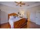 Bedroom featuring a hardwood floor, ceiling fan, and a wooden bed with decorative wall art at 13338 Jaudon Ranch Rd, Dover, FL 33527
