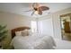 Bright bedroom with a bed, a ceiling fan, neutral walls, and closet at 13338 Jaudon Ranch Rd, Dover, FL 33527