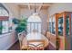 Dining room with hardwood floors, coffered ceiling, decorative hutch, and large window with plantation shutters at 13338 Jaudon Ranch Rd, Dover, FL 33527