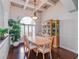 Formal dining room with hardwood floors, coffered ceiling, and large arched window with plantation shutters at 13338 Jaudon Ranch Rd, Dover, FL 33527