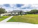 Charming single-story home featuring manicured lawn and mature landscaping at 13338 Jaudon Ranch Rd, Dover, FL 33527