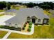Charming exterior featuring stone accents, arched windows, manicured shrubs, a spacious yard, and a detached garage at 13338 Jaudon Ranch Rd, Dover, FL 33527
