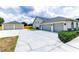 Spacious driveway and two-car garage with detached two-car garage and neutral paint at 13338 Jaudon Ranch Rd, Dover, FL 33527