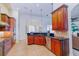Features cherry wood cabinetry, tile flooring, granite countertops, and modern stainless steel appliances at 13338 Jaudon Ranch Rd, Dover, FL 33527