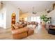 Open concept living room with tile floors, leather furniture, and decorative accents at 13338 Jaudon Ranch Rd, Dover, FL 33527