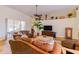 Comfortable living room with brown leather furniture, high ceilings, and decorative shelving at 13338 Jaudon Ranch Rd, Dover, FL 33527
