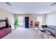 Loft area with comfortable seating, neutral carpet, and natural light at 13338 Jaudon Ranch Rd, Dover, FL 33527
