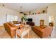 Bright living room showcasing tile floors, neutral walls, and leather furniture at 13338 Jaudon Ranch Rd, Dover, FL 33527