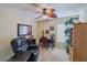 Home office features a ceiling fan, natural light, and comfortable seating at 13338 Jaudon Ranch Rd, Dover, FL 33527