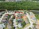 Aerial view of the property situated in a serene neighborhood surrounded by lush greenery and waterways at 1447 Stetson Dr, Wesley Chapel, FL 33543