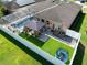 Aerial view of a backyard oasis with a screened pool, gazebo, lush turf, and white privacy fence at 1447 Stetson Dr, Wesley Chapel, FL 33543