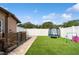 Backyard featuring artificial grass, a trampoline, decorative rocks, and a privacy fence at 1447 Stetson Dr, Wesley Chapel, FL 33543