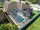 Aerial view of a backyard with a screened pool, gazebo, artificial turf, and a white vinyl privacy fence at 1447 Stetson Dr, Wesley Chapel, FL 33543