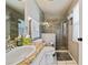 Modern bathroom boasts a glass-enclosed shower, granite vanity, and contemporary fixtures at 1447 Stetson Dr, Wesley Chapel, FL 33543