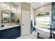 Elegant bathroom featuring a standalone tub, stylish vanity, and modern fixtures at 1447 Stetson Dr, Wesley Chapel, FL 33543