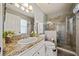 Elegant bathroom featuring a granite countertop, glass-enclosed shower, and neutral color scheme at 1447 Stetson Dr, Wesley Chapel, FL 33543