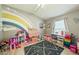 Bright bedroom featuring a colorful rainbow mural, stylish decor, and a playful atmosphere at 1447 Stetson Dr, Wesley Chapel, FL 33543