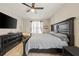 Bedroom features a ceiling fan and window, and includes dark wood furniture at 1447 Stetson Dr, Wesley Chapel, FL 33543