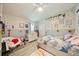 Charming bedroom with soft pastel decor, decorative wall hangings, and a cozy reading nook at 1447 Stetson Dr, Wesley Chapel, FL 33543