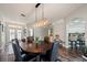 Dining area boasts hardwood floors, a modern chandelier and seating for six at 1447 Stetson Dr, Wesley Chapel, FL 33543