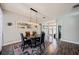 Dining room showcases a modern chandelier, hardwood floors, and seating for four at 1447 Stetson Dr, Wesley Chapel, FL 33543