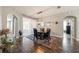 Dining room features dark hardwood floors and modern lighting, with seating for four at 1447 Stetson Dr, Wesley Chapel, FL 33543