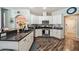 Bright kitchen features white cabinets, stainless steel appliances, and wood floors at 1447 Stetson Dr, Wesley Chapel, FL 33543