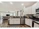 Modern kitchen with stainless steel appliances, granite countertops, and an open layout to the living room at 1447 Stetson Dr, Wesley Chapel, FL 33543