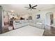 Spacious living room features a comfortable sectional sofa with direct view into the kitchen and dining area at 1447 Stetson Dr, Wesley Chapel, FL 33543