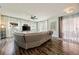 Bright living room features a sectional sofa, wood floors, and access to the outdoor living space at 1447 Stetson Dr, Wesley Chapel, FL 33543