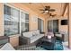 Covered patio with comfortable wicker furniture, ceiling fans, and a view of the outdoors at 1447 Stetson Dr, Wesley Chapel, FL 33543