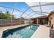 Inviting screened-in pool with ample seating and sunbathing space, perfect for relaxation and outdoor entertaining at 1447 Stetson Dr, Wesley Chapel, FL 33543