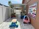 Covered outdoor area perfect for a Gathering care with ride-on toys and care advertisement at 14502 Farm Hills Pl, Tampa, FL 33625