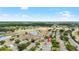 Charming aerial view of the home with lush landscaping, a golf course, and a pond at 1530 Ingram Dr # 1530, Sun City Center, FL 33573