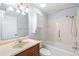Bathroom with shower and tub combo, updated vanity, and cabinet storage at 1530 Ingram Dr # 1530, Sun City Center, FL 33573