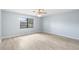 Bright bedroom with wood flooring, ceiling fan, and a sunny window view at 1530 Ingram Dr # 1530, Sun City Center, FL 33573