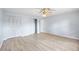 Spacious bedroom with wood flooring, closet storage, and an open doorway at 1530 Ingram Dr # 1530, Sun City Center, FL 33573