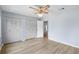 Bedroom features wood flooring, ceiling fan, light blue walls and closet storage at 1530 Ingram Dr # 1530, Sun City Center, FL 33573