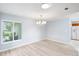 Bright dining room with large window and chandelier, seamlessly connected to the kitchen, perfect for entertaining at 1530 Ingram Dr # 1530, Sun City Center, FL 33573